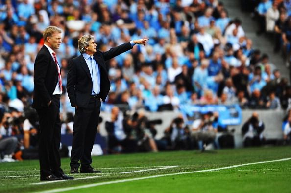 David Moyes manager of Manchester United (L) and Manuel Pellegrini manager of Manchester City look on during the Barclays Premier League match between Manchester City and Manchester United at the Etihad Stadium on September 22, 2013 in Manchester, England. (Getty Images)